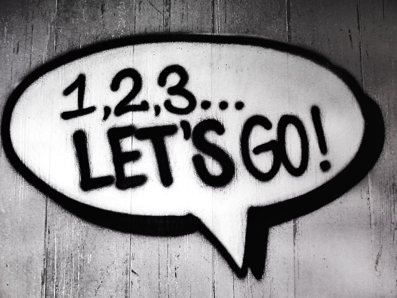 our-services-1 Black and white street art featuring a bold motivational message in a speech bubble.