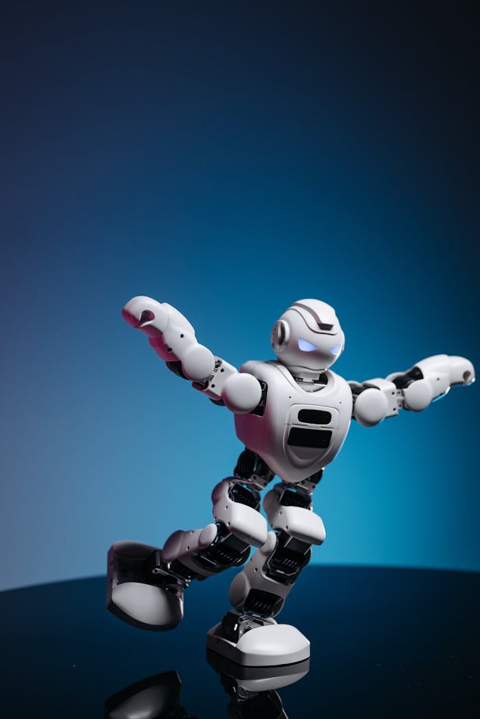 gallery-2 White humanoid toy robot with glowing eyes displayed in a dynamic pose.